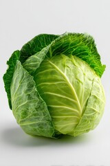 Obraz premium Fresh green cabbage with smooth tightly packed leaves isolated on a pure white seamless studio background