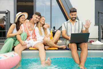 A lively atmosphere as friends share laughs and refreshing drinks by the pool, highlighting summer...
