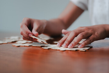 Engaging business strategy session office puzzle solving collaborative environment close-up...
