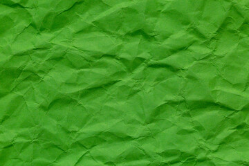 Close-up of green crumpled paper,A close-up, top-down shot showcases the crinkled and uneven...