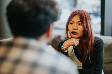 Business associates discussing important details with professional focus and engagement in a cafe.