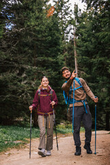 Curious Hiking Couple Observing the Distant View in Mountain Forest
