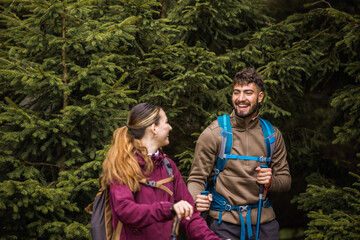 Young Couple Hiking Through Rough Mountain Path and Bushes with Full Gear