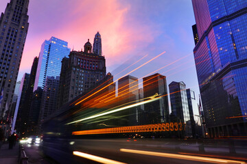 Chicago Skyline of Buildings with Sunset and Car Traffic Driving By on Michigan Avenue