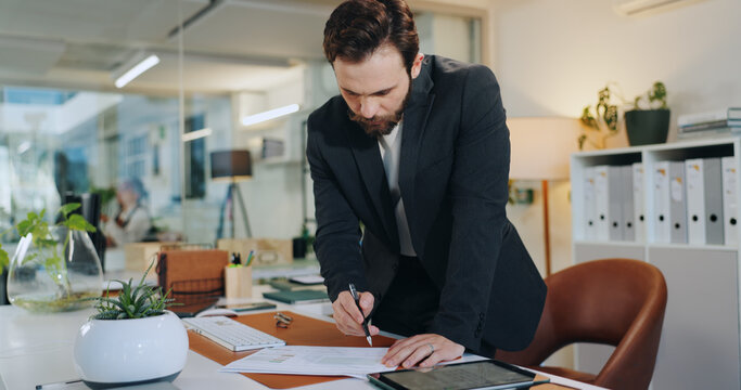 Signing, document and man in office, entrepreneur and agreement for business loan, funding or grant. Writing, paperwork and person with investment contract, terms and policy on table and approval