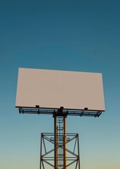 A stark white billboard a silent testament to the passage of time stands majestically against a cerulean sky its surface bathed in the golden embrace of the sun a canvas waiting for a message to be pa
