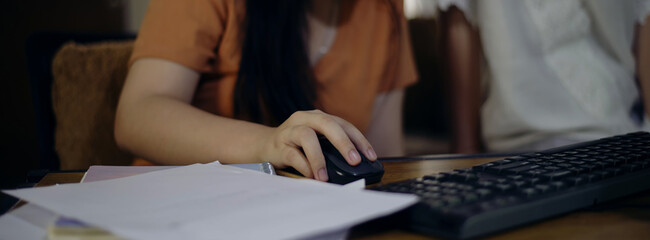 Asian children using digital tablet with stylus pen write and do homework at home. Stress Thai...