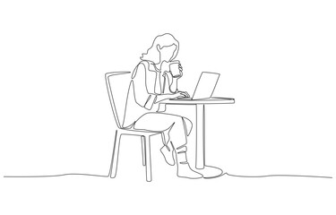Freelancer working on her laptop with a coffee cup in hand
