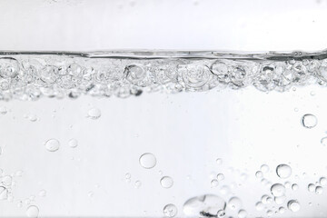 Crystal-clear liquid with rising bubbles, symbolizing purity, hydration, and freshness. Perfect for...