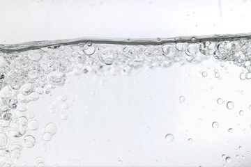 Crystal-clear liquid with rising bubbles, symbolizing purity, hydration, and freshness. Perfect for...