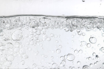 Crystal-clear liquid with rising bubbles, symbolizing purity, hydration, and freshness. Perfect for...