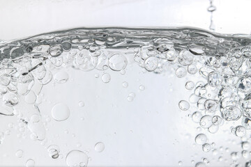 Crystal-clear liquid with rising bubbles, symbolizing purity, hydration, and freshness. Perfect for...