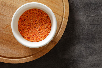 raw orange lentils in bowl, top view