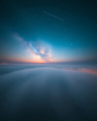 Majestic twilight above the clouds reveals a captivating sky painted in hues of blue and orange
