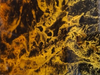 Abstract shapes and fluids, yellow forms on black background