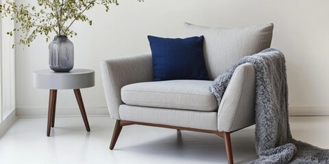 Interior of living room. Gray armchair, green pillow, coffee table and beige wall. Velour Chair against light wall, wooden floor, parquet. Home improvement. Beautiful luxurious modern room settings.