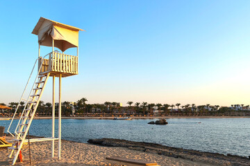 A lifeguard tower stands on a sandy beach by the Red Sea in Egypt. The scene captures a clear...