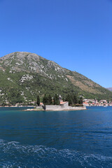 Saint George Island with mountains in the background, in the Bay of Kotor, Montenegro