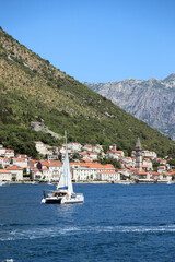 sailboat against the backdrop of the old town of Perast