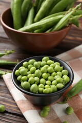 Fresh ripe green peas on wooden table, closeup
