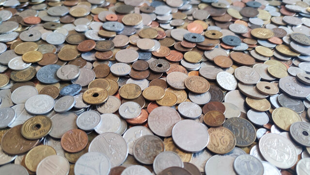 Coins from around the world. Numismatics. Coins background. Heap of various coins. Coins collection.