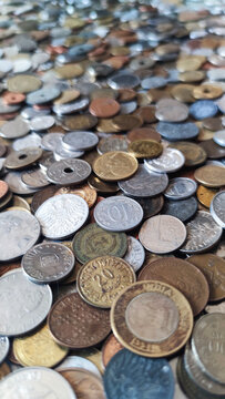 Coins from around the world. Numismatics. Coins background. Heap of various coins. Coins collection.