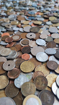 Coins from around the world. Numismatics. Coins background. Heap of various coins. Coins collection.