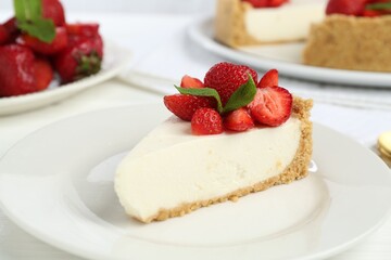Piece of tasty cheesecake with strawberries and mint on table, closeup