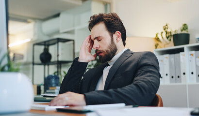 Naklejka premium Burnout, sleep or businessman with headache in office for deadline, project report and pain. Stress, tired and exhausted administrator with depression or migraine with fatigue, crisis or pressure