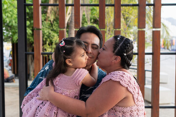 Fototapeta premium Hispanic family sharing a tender moment of affection