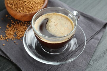 Aromatic instant coffee on black table, closeup