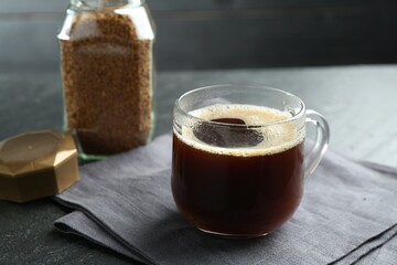 Aromatic instant coffee on black table, closeup