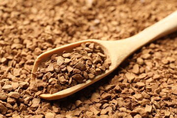 Spoon with aromatic instant coffee as background, closeup