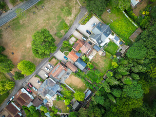 Aerial view of fine, detached and large private houses located within a rural community in England. Seen adjacent to the village green.