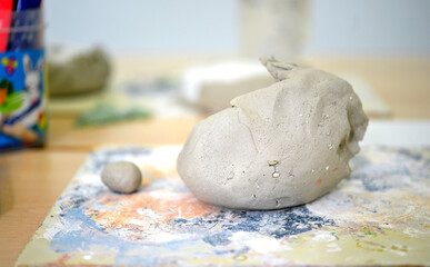 Concept Crafting and Creativity: View of a table with various clay-making materials and two shaped...
