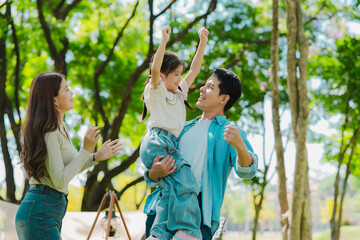 Asian family traveling and camping in the forest feeling happy during family time, adventure and...
