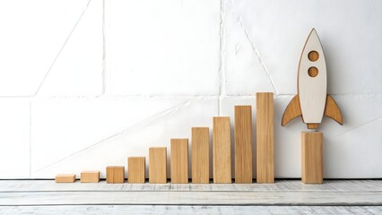 Wooden blocks forming bar chart with rocket launch concept