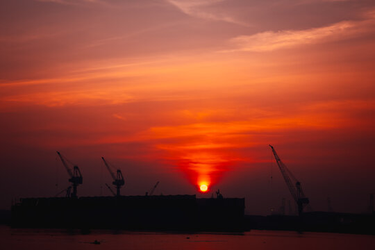 morning sunbackground, shipyard dry dock and crane for maintenance and repair container ship transport and oil ships in sea, business and industry service