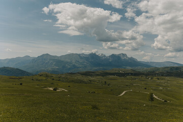 Fototapeta premium Amazing view of valley, road and mountains in Durmitor National Park, Montenegro on a summer day.
