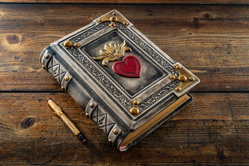 vintage leather book with the Sacred Heart of Jesus symbol 