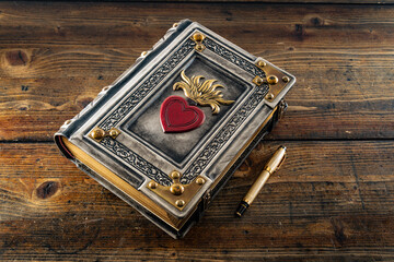 vintage leather book with the Sacred Heart of Jesus symbol 