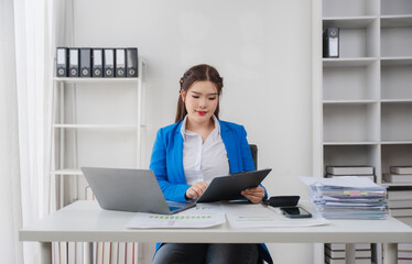 Focused Work: A professional individual in a modern office setting, diligently reviewing documents,...