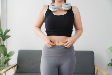 Body Shape Assessment: A close-up perspective showing a person pinching skin around belly,...