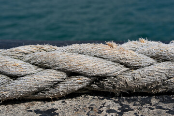 Rope on the background of the sea, closeup of photo, Rope on a mooring bollard with sea background