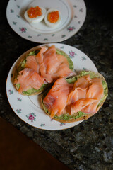Delicious smoked salmon on avocado toast served at a cozy kitchen breakfast setting in the morning