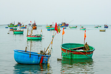 Colorful Basket Boats Floating Calmly in Mui Ne Bay, a Traditional Vietnamese Fishing Scene