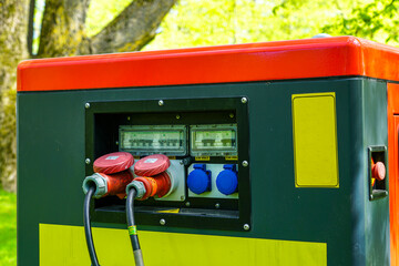 Close-Up of Power Generator Panel with 230V Sockets and Cables in Outdoor Energy Setup