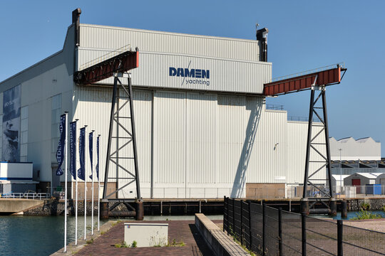 Damen Yachting hall in Vlissingen with Scheldekwartier flags on quay front
