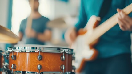 Musicians practicing in a colorful studio, with reflections on a polished drum and ample space for branding. Focus on creativity and rhythm