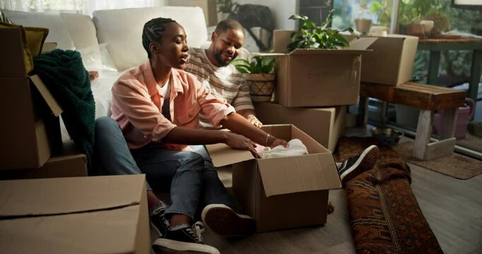 Real estate, couple and unpacking boxes in new house for moving in, property purchase and teamwork. Excited, black people and helping with unboxing clothes in first home for relocation or achievement